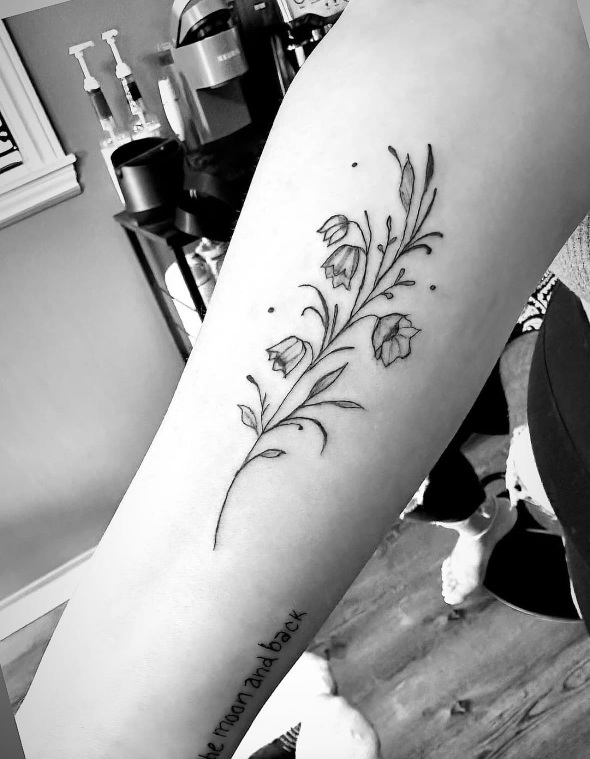 Fine line floral tattoo on forearm