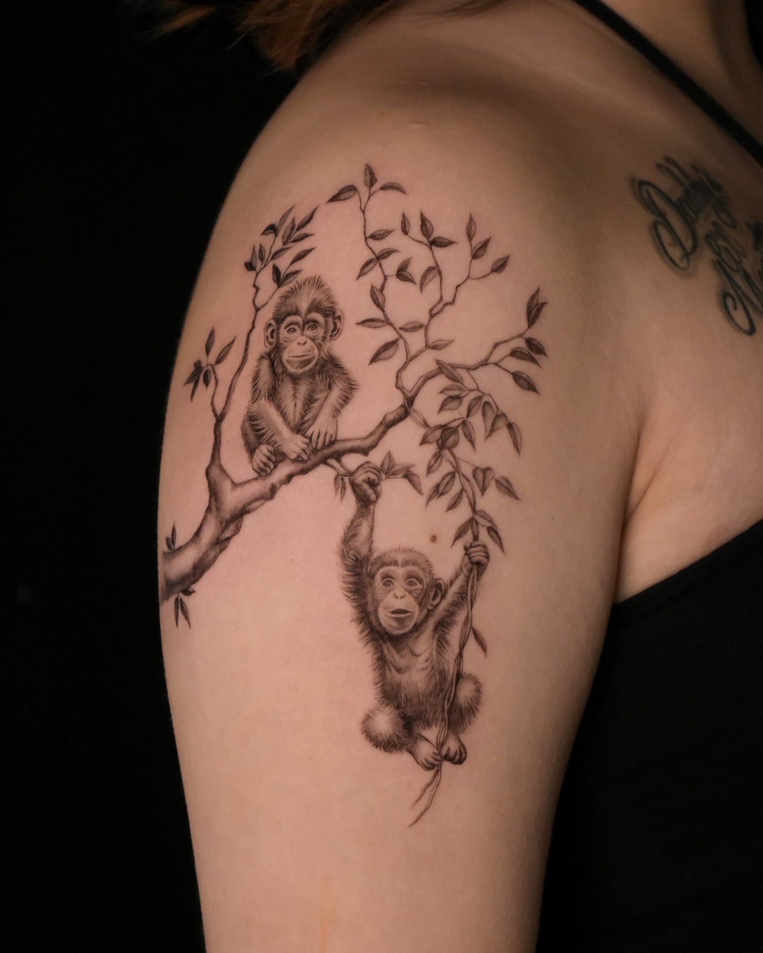 Black-and-grey chimpanzees-on-a-branch tattoo, work attributed to Jesse