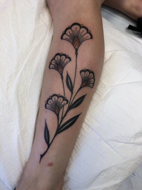 art deco flower tattoo on forearm