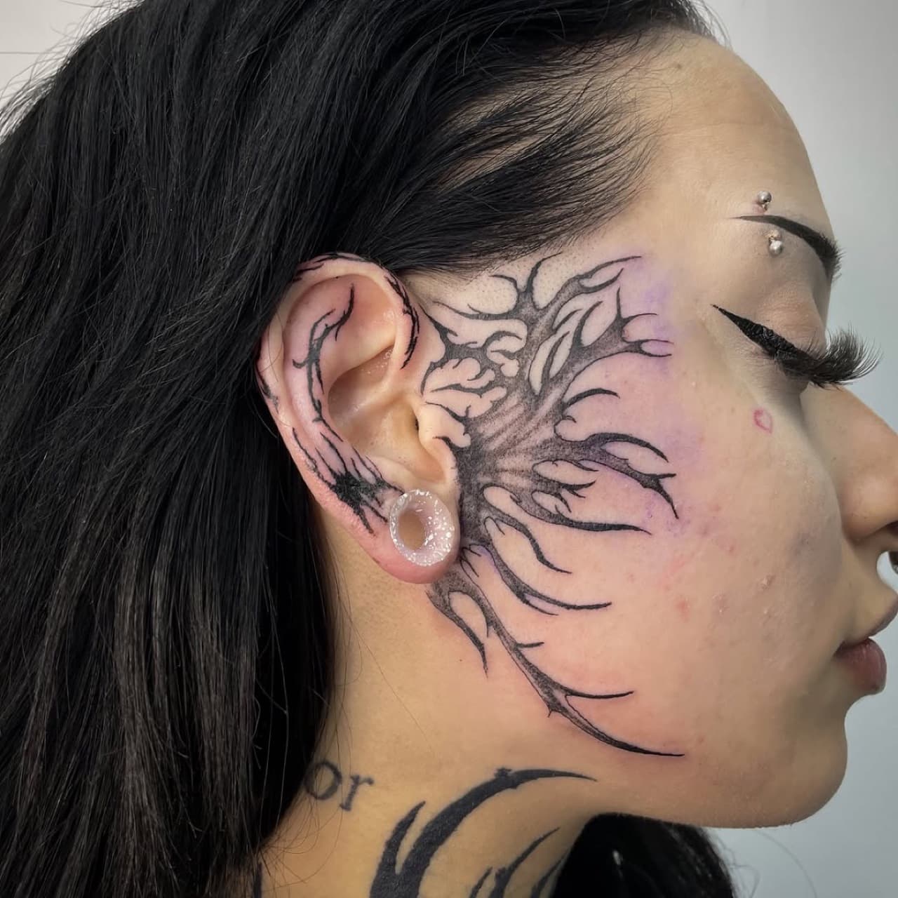 Fine line floral face tattoo at Yes Electric Tattoo Toronto