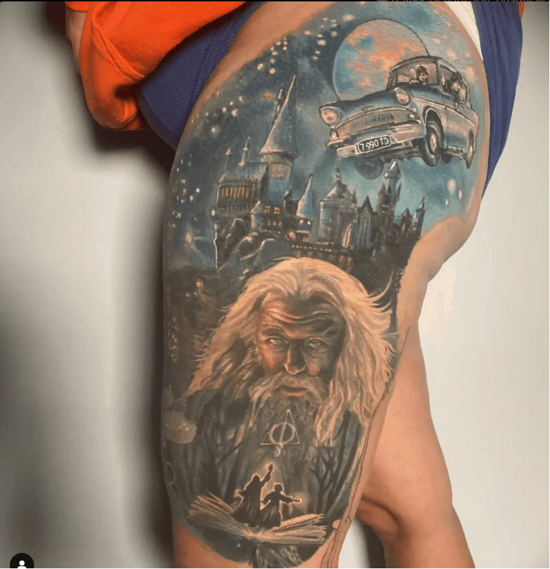 Color realism tattoo of Dumbledore with Hogwarts and flying car scene by Jodie Wentz Winnipeg