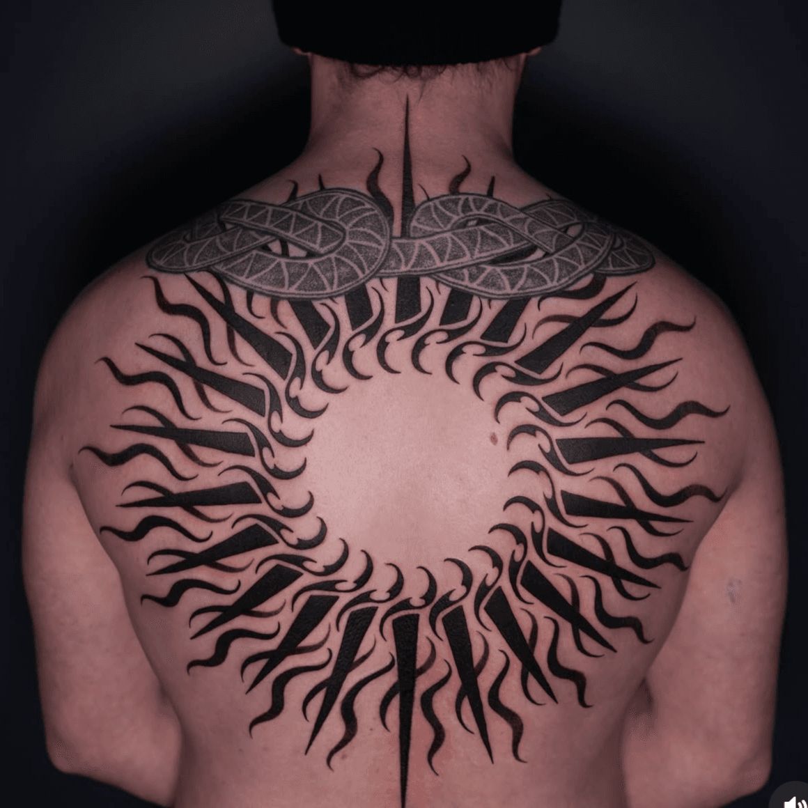 Large ornamental blackwork back piece built from a radiating ring of solid black shapes, attributed to Eunseo on her Jade and Dagger profile page