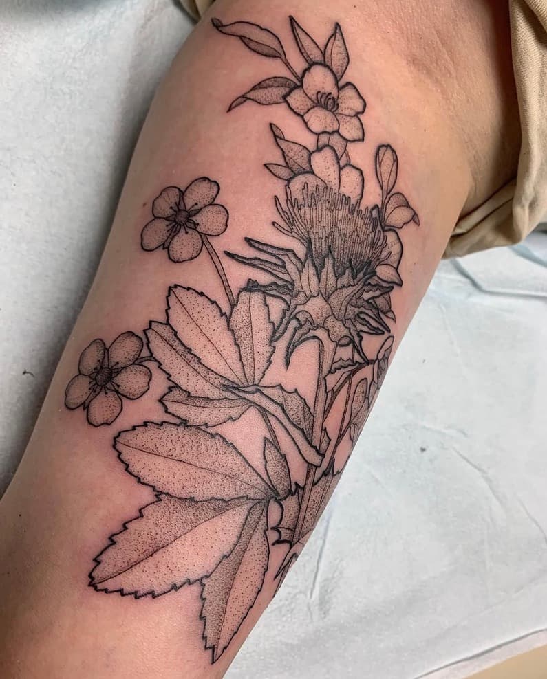 Fine black botanical bouquet with stippled flowers and leaves on the upper arm