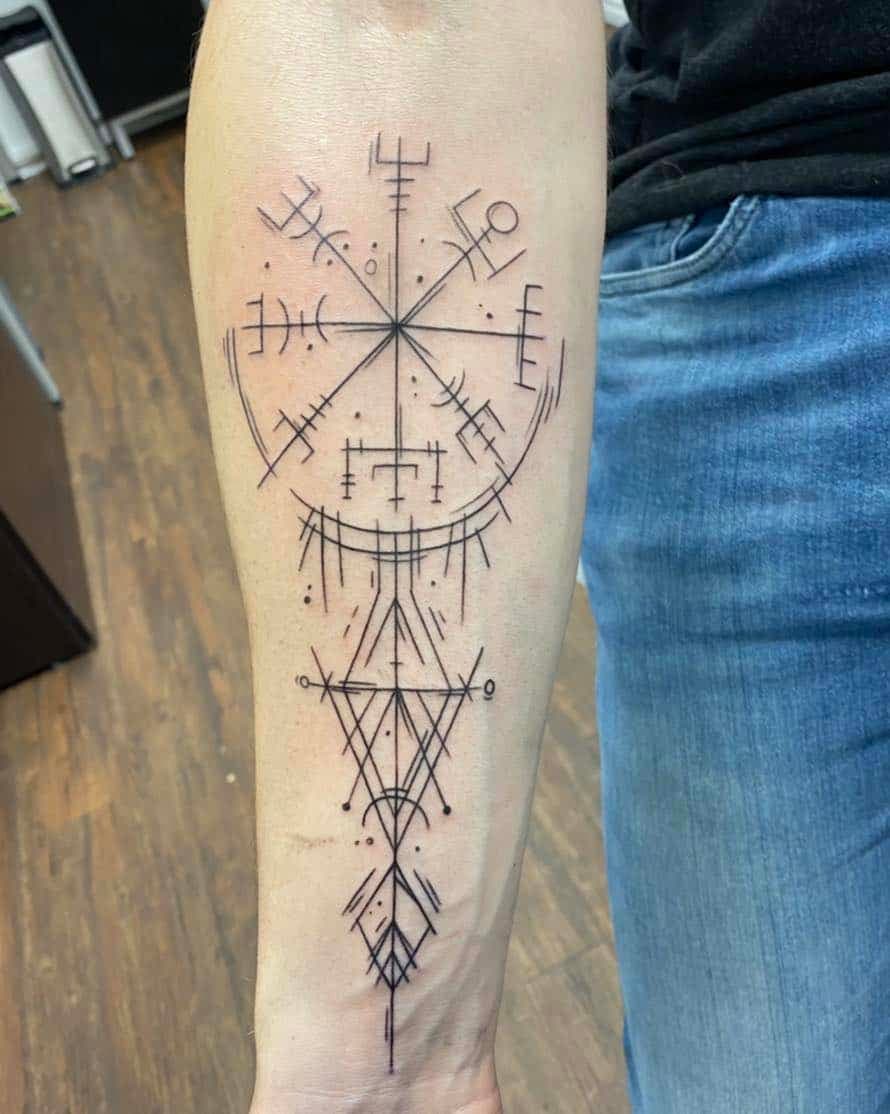 Fine line geometric forearm tattoo by Akira featuring a Vegvísir-inspired compass symbol with intricate rune-like markings and symmetrical abstract linework ext