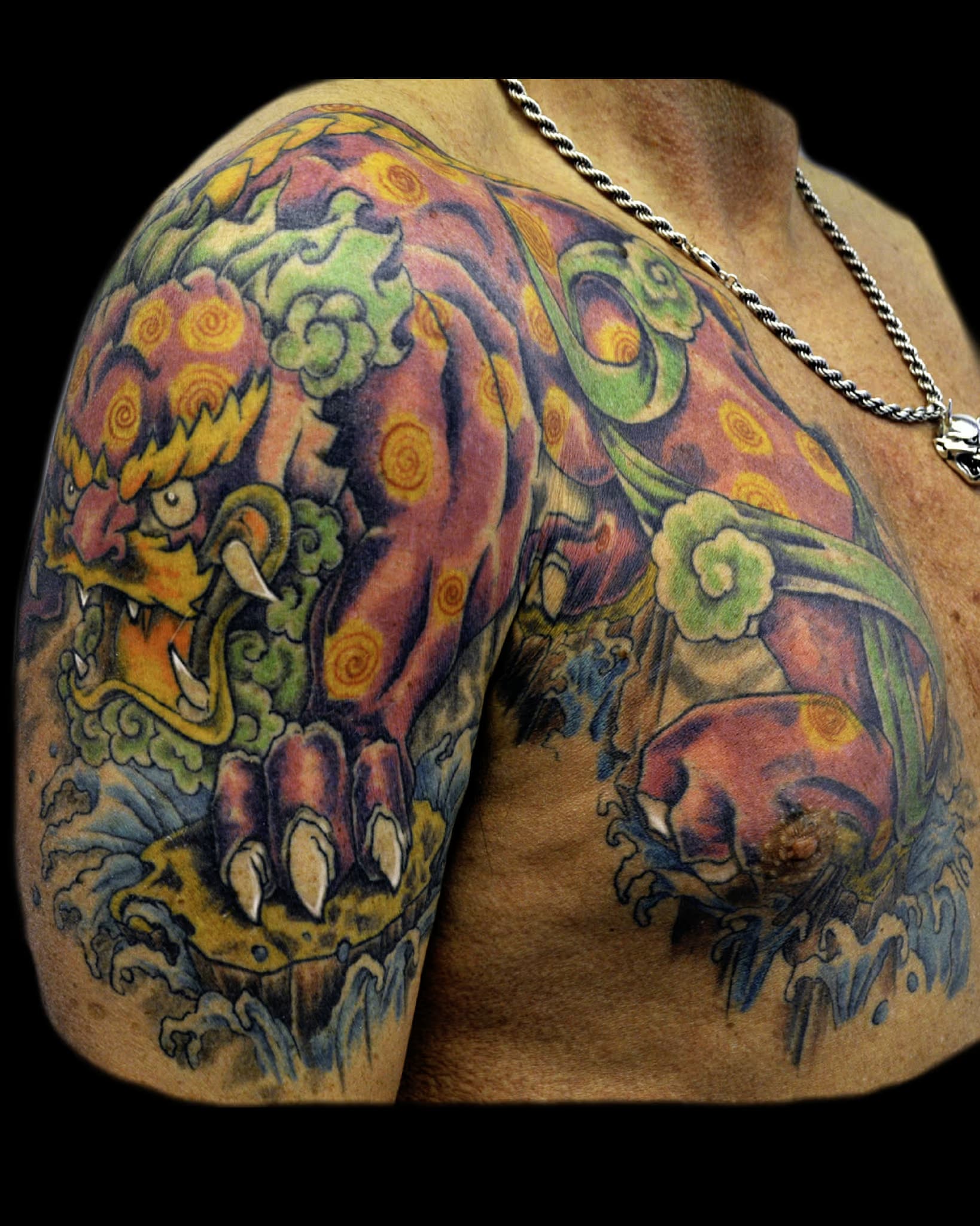 an intricate tattoo artwork by bear, a chinese dragon in red.
