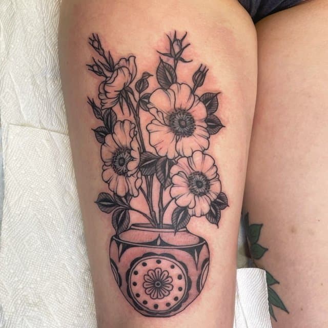 black work poppies in vase tattoo