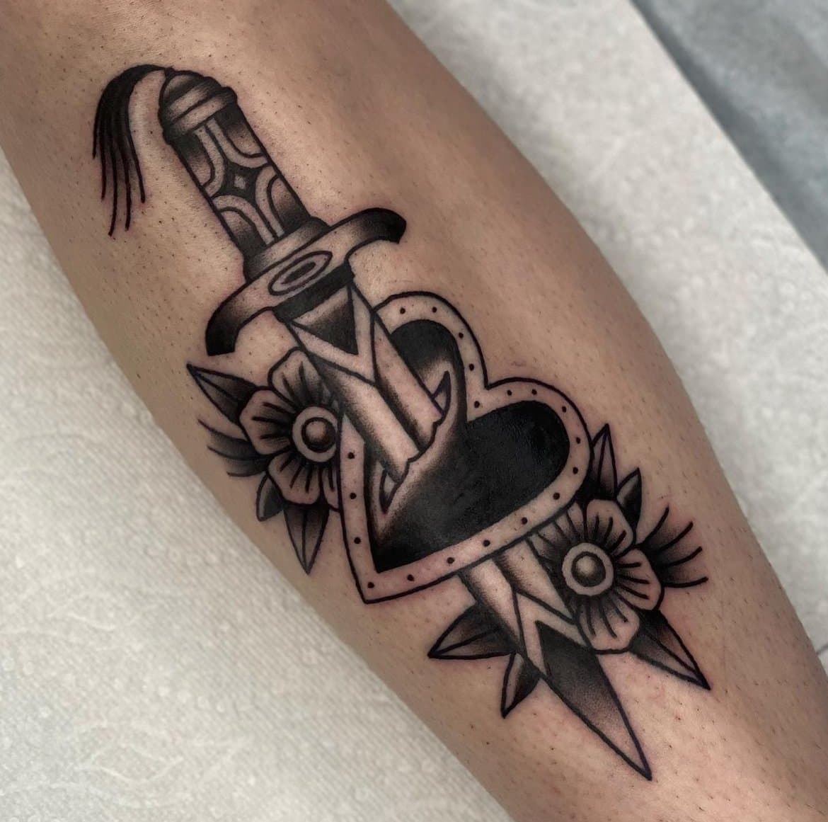 American traditional dagger through heart, black work tattoo