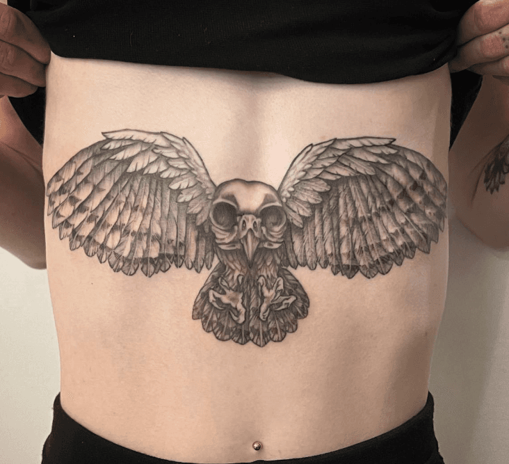 black and grey illustrative skull owl tattoo on stomach done in toronto