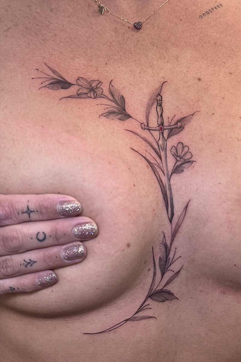 fineline-tattoo-sternum-flowers-sword