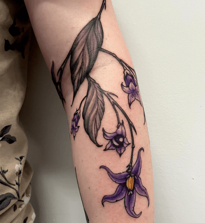 black and grey colour belladonna tattoo on arm done in toronto