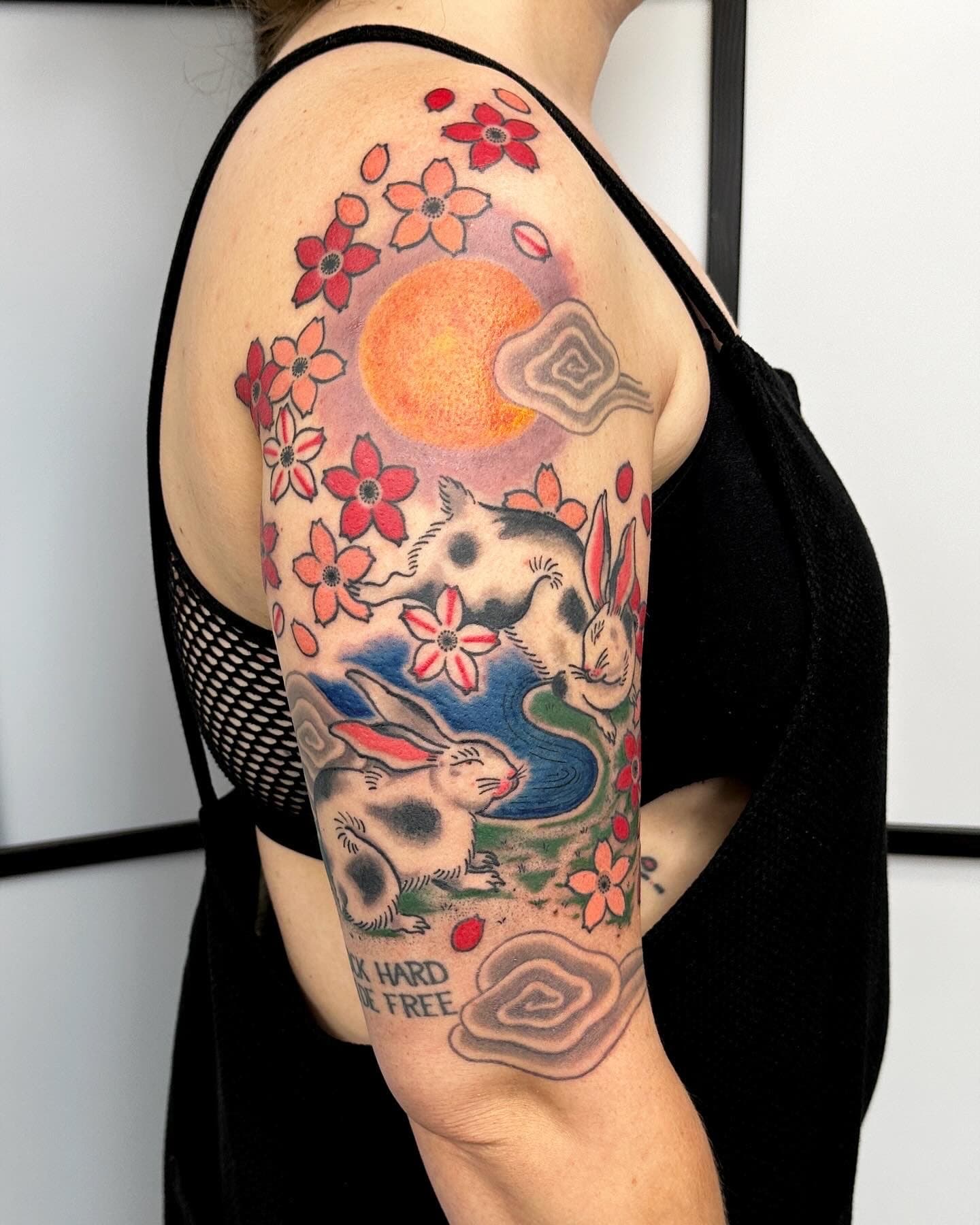 Colourful Japanese style bunny rabbits and cherry blossoms, upper arm tattoo in Vancouver, BC.