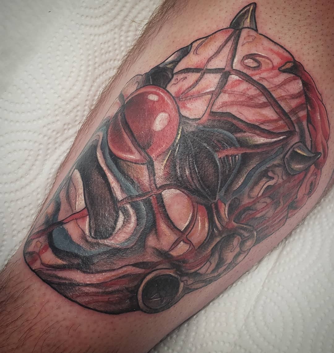 Tattoo of a comic-style Iron Man mask on someone’s arm