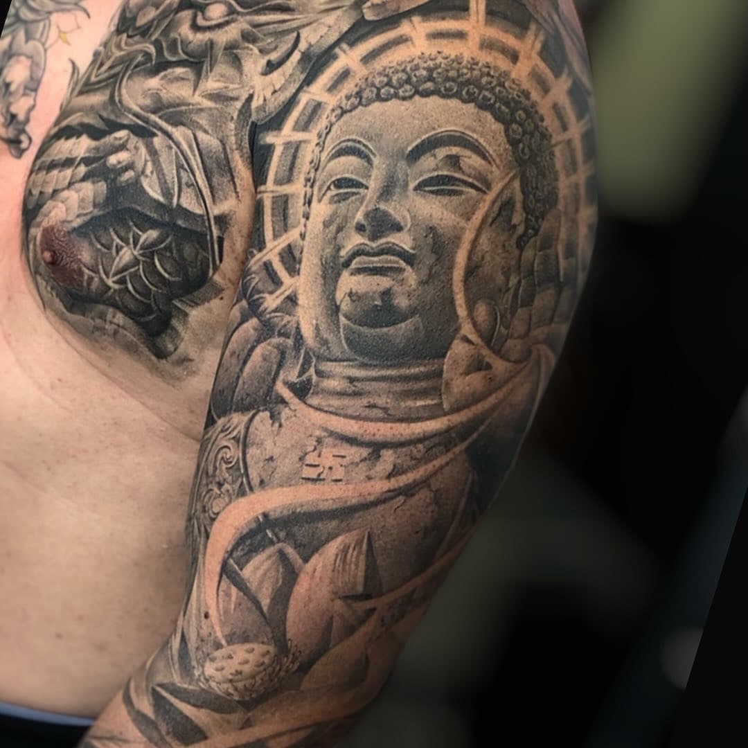 Full sleeve of realistic buddha tattoo