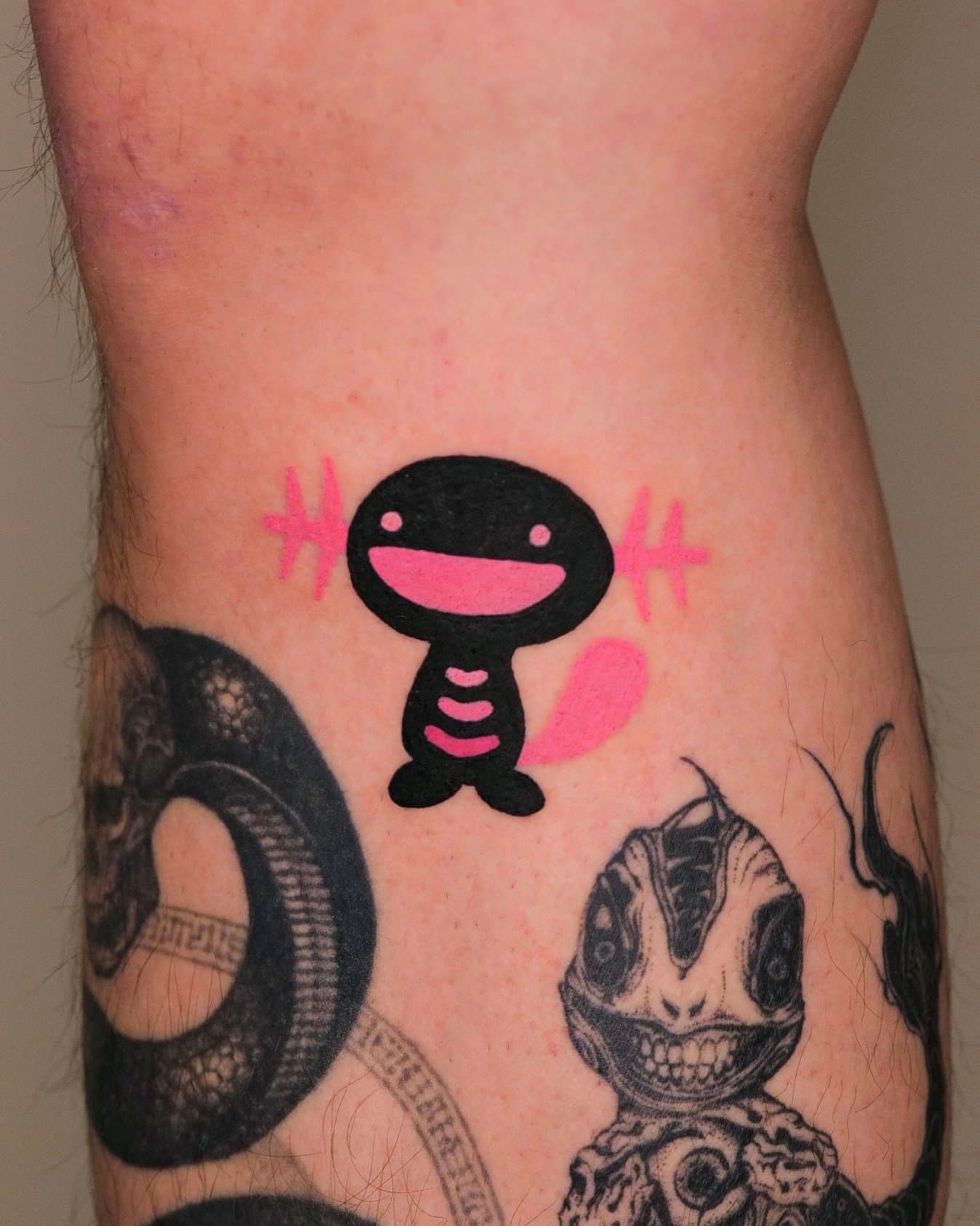 Smiling black round-headed character with bright pink cheek and motion accents