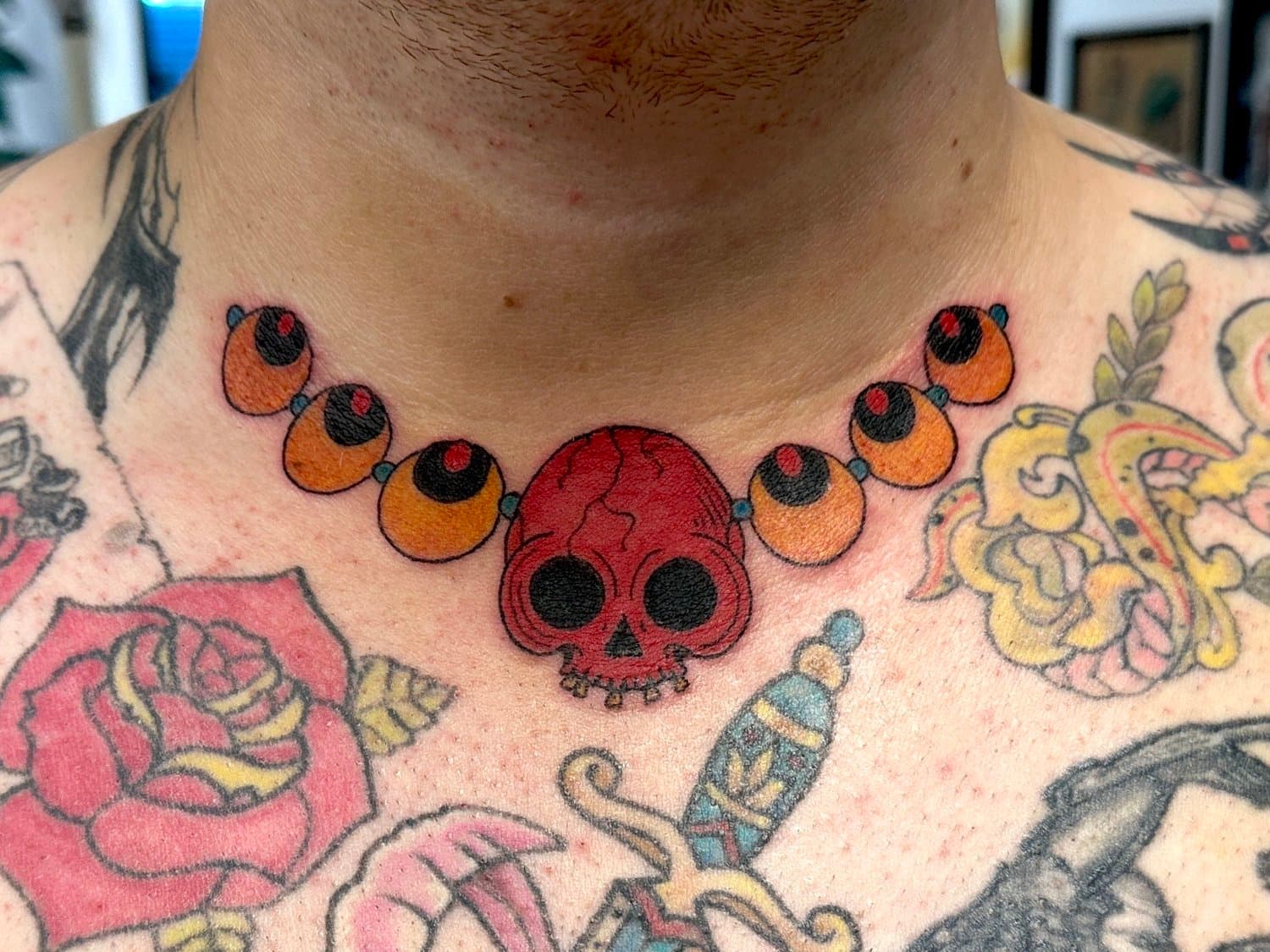 Skull and hoju necklace tattoo.