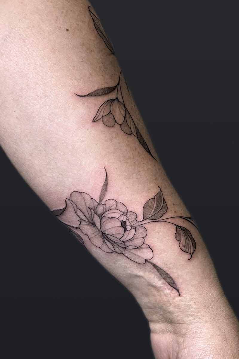 Atticus Tattoo| Fineline tattoo of a peony wrap
