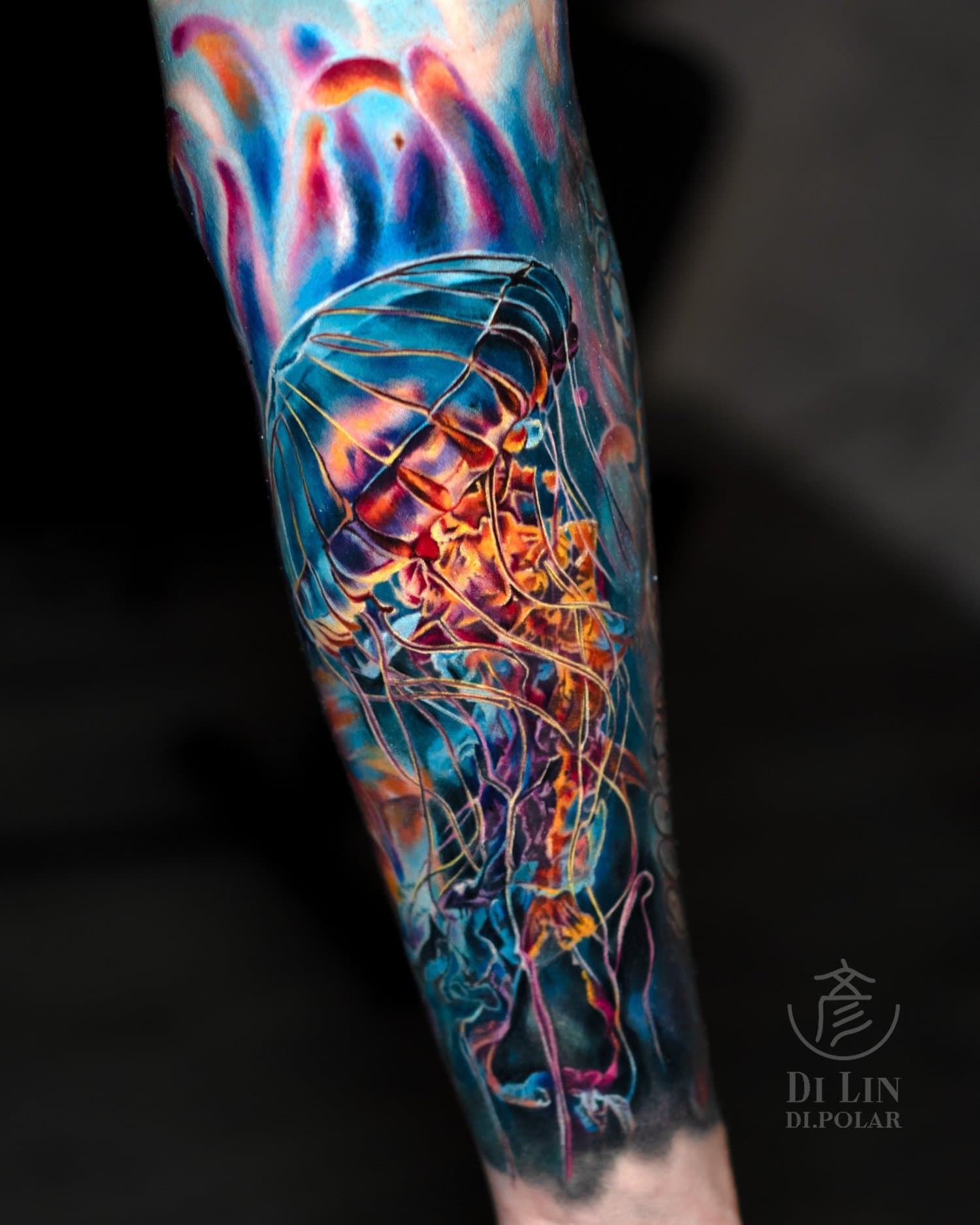 Colourful jellyfish realism tattoo with electric blue, orange, pink, and yellow light effects