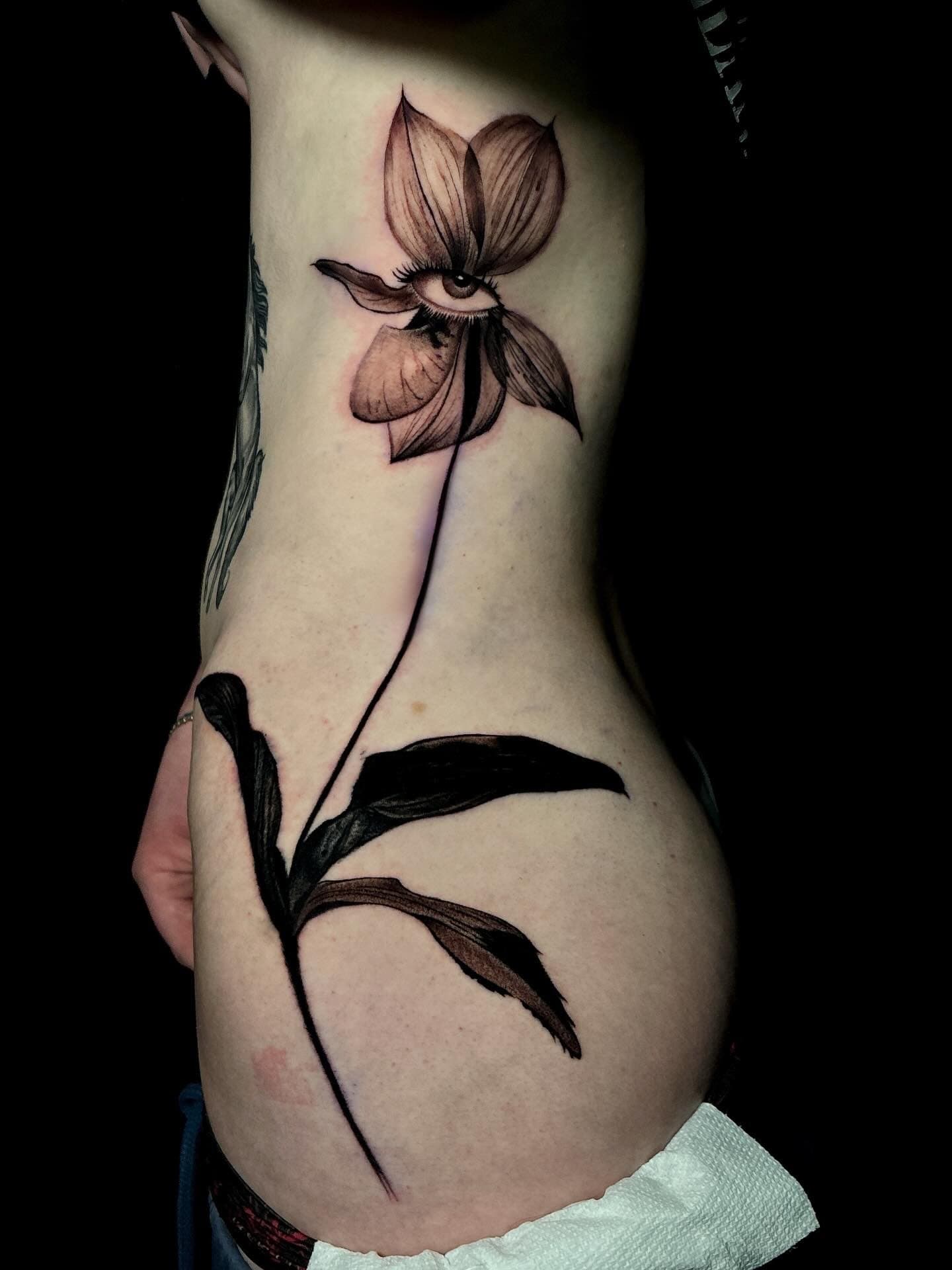 Tattoo of a flower with an eye in the center Surrealism Tattoo Done by Pablo at Ink Terminal Ottawa Gatineau
