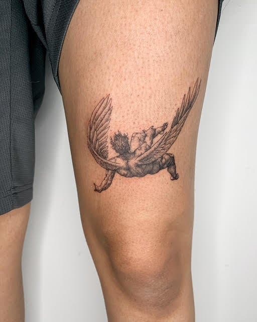Tattoo of a winged horse with a muscular human torso on a person's upper thigh.