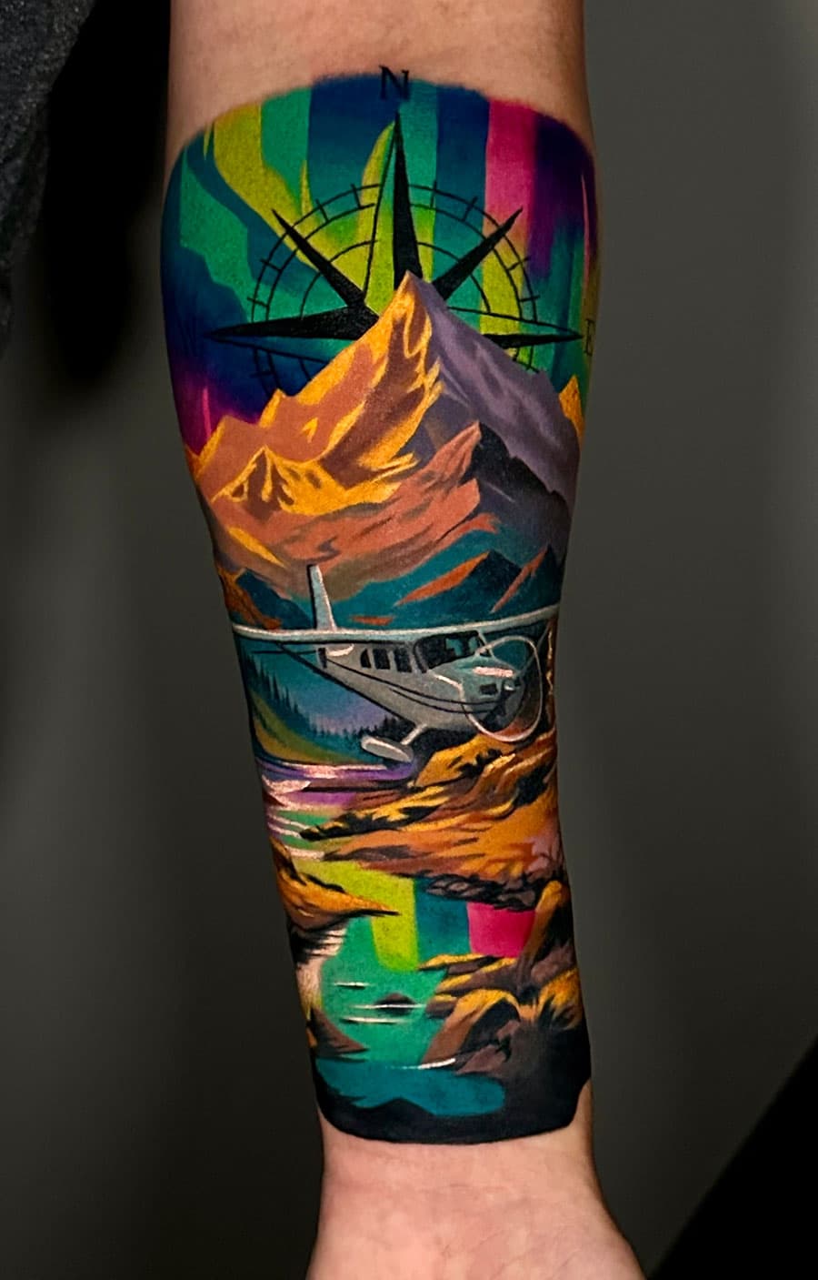 Plane and colour landscape tattoo by Artem Nebesnyi