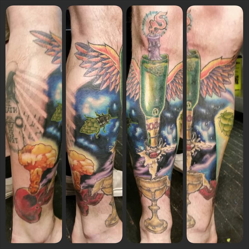 Lower leg sleeve tattoo commemorating a father-son brewing endeavour. Beer, Hops, Outer-space and skulls with mushroom clouds.
