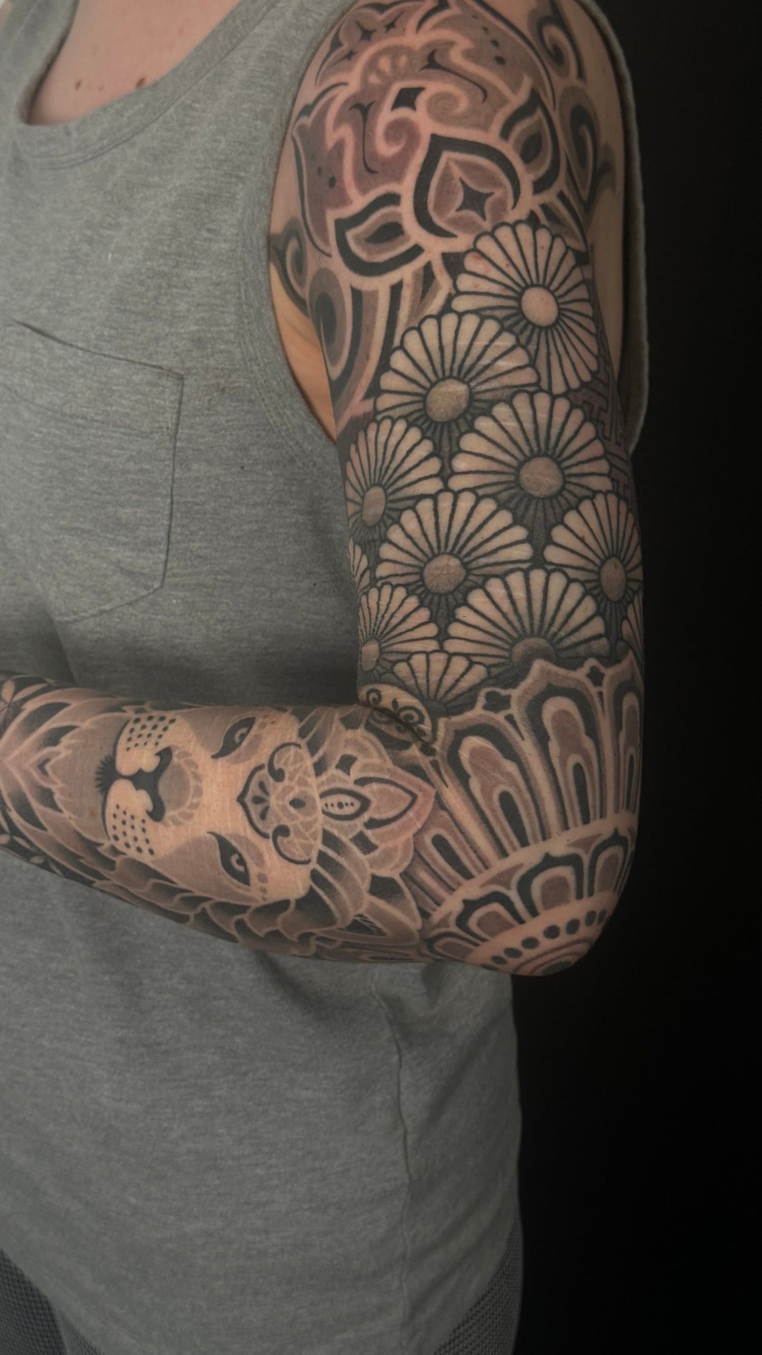geometric sleeve scare cover up lion lotus tattoo