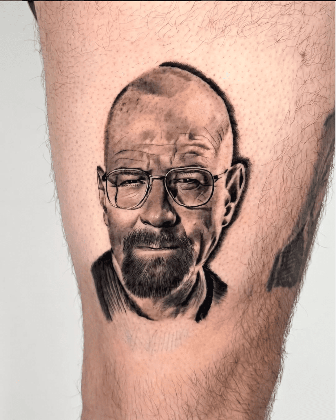 Black and grey celebrity portrait tattoo — Walter White by Luis Fernandez at Zen Tattoo Studio, Oakville. Photorealistic TV character portrait, thigh placement,