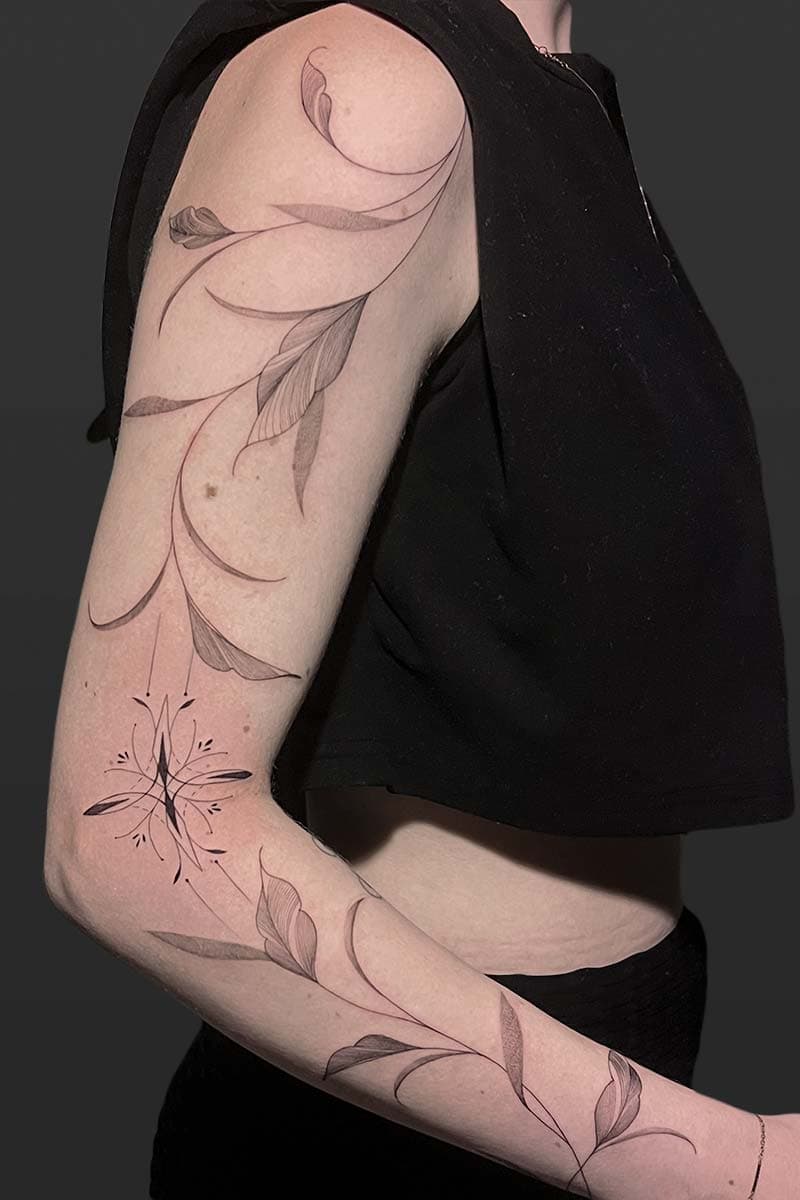 Atticus Tattoo| Fineline tattoo of an ornamental design and a vine of leaves