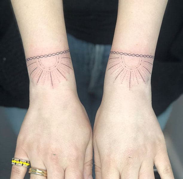 A person with a tattoo on both wrists