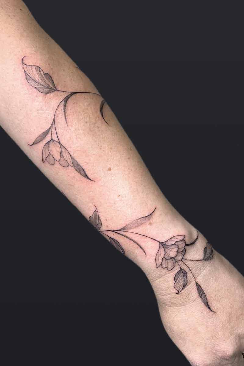 Atticus Tattoo| Fineline tattoo of a flower wrap