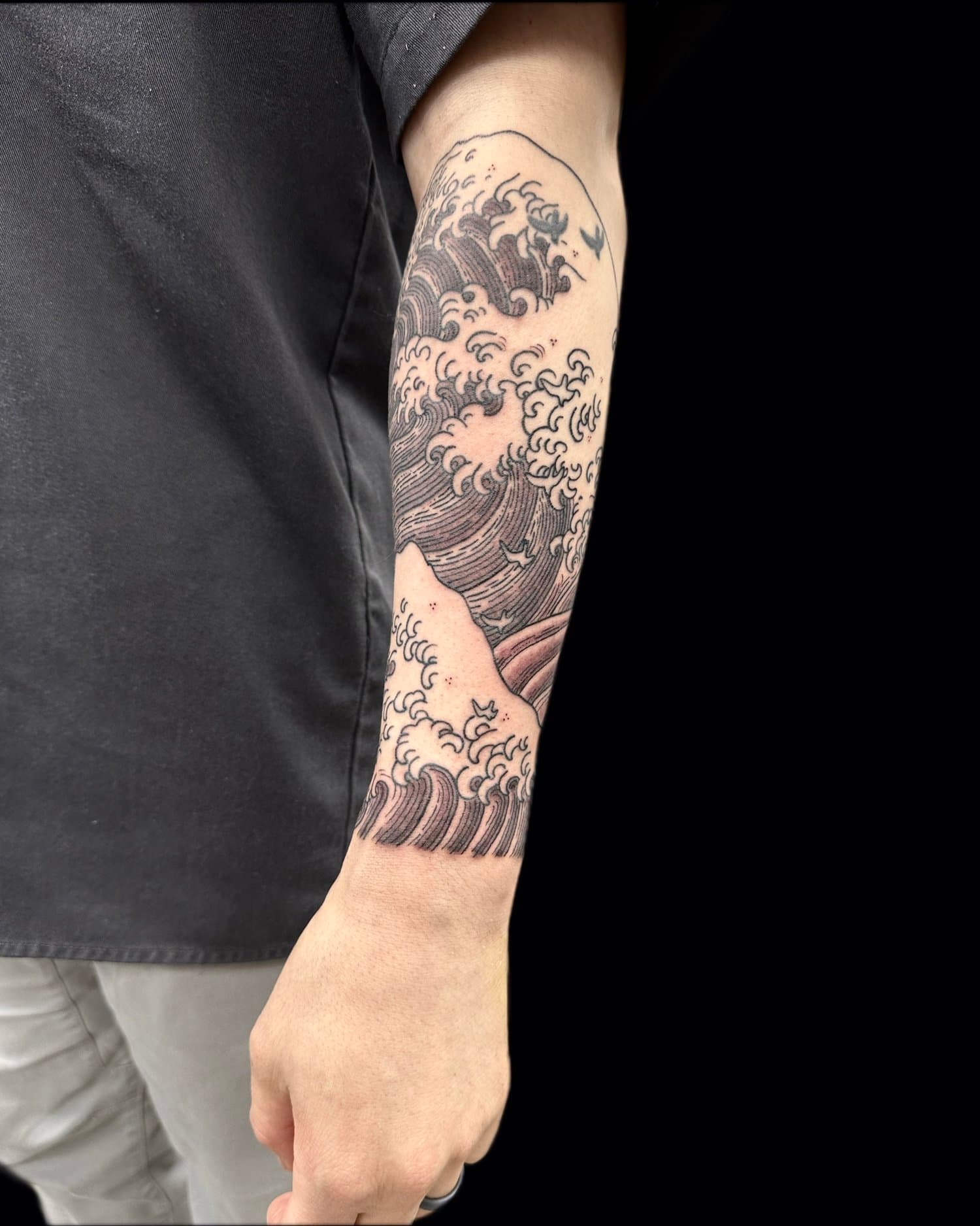 Great wave of Kanagawa tattoo referenced from Hokusai, on forearm.