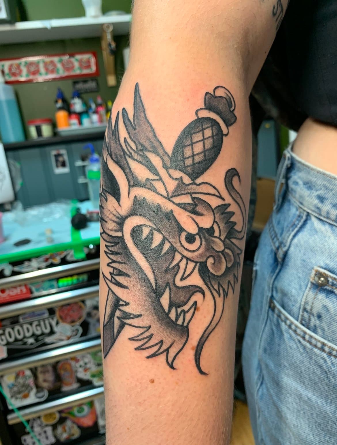 American traditional black and grey dragon head with dagger tattoo