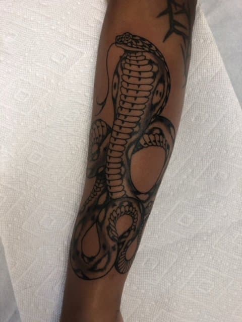 Black work snake tattoo done in Vancouver, BC